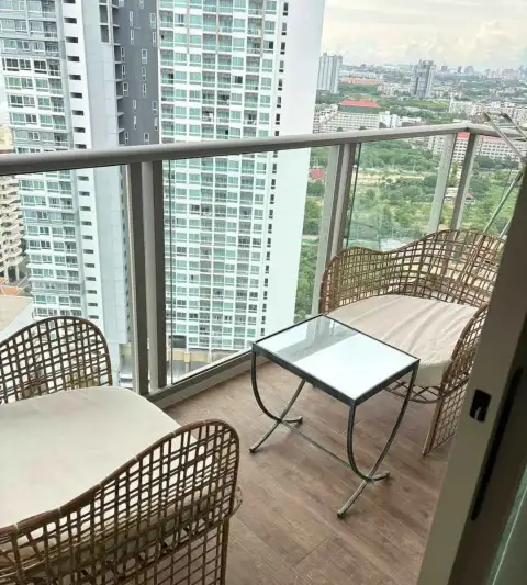 1 Bedroom Condo for Rent at Riviera Monaco balcony with rattan chairs, glass table and city skyline view