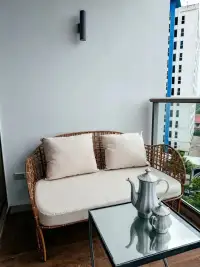 1 Bedroom Condo for Sale at Riviera Monaco balcony seating with rattan sofa and city view
