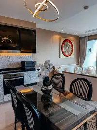1 Bedroom Condo for Sale at Riviera Monaco dining area with marble kitchenette and modern light fixture