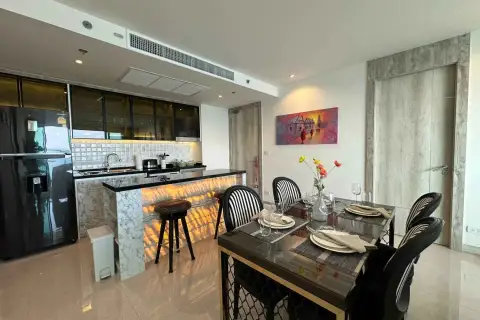 2 Bedroom Condo for Rent at Riviera Monaco open kitchen with marble island and formal dining table setup