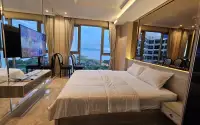 2 Bedroom Condo for Sale & Rent at Riviera Monaco bedroom with mounted TV, mirrored panels and ocean view balcony