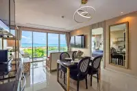 2 Bedroom Condo for Sale at Riviera Monaco dining area with ocean view and round chandelier