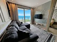1 Bedroom Condo for Sale at Riviera Monaco living room with sectional sofa and ocean view balcony