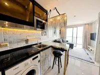 1 Bedroom Condo for Sale at Riviera Monaco kitchenette with marble backsplash and dining counter view
