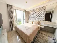 1 Bedroom Condo for Sale at Riviera Monaco bedroom with tufted headboard and city view windows