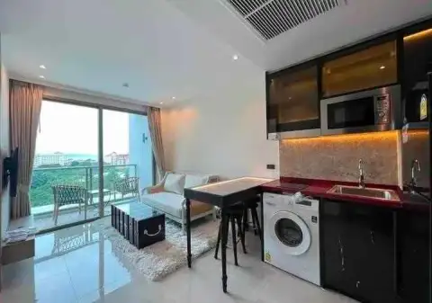 1 Bedroom Condo for Rent at Riviera Ocean Drive open-plan kitchenette with washing machine and balcony access