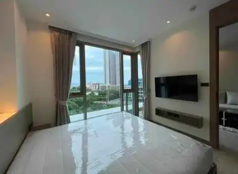 1 Bedroom Condo for Rent at Riviera Ocean Drive bedroom with city view through glass balcony doors