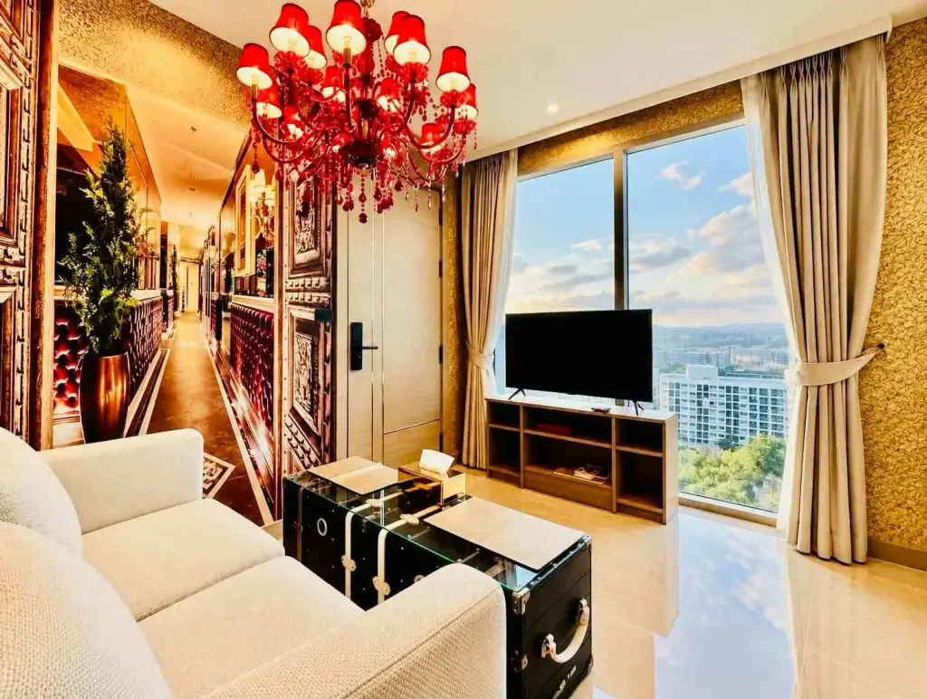 1 Bedroom Condo for Rent at Riviera Ocean Drive living room with red chandelier, sofa, and city view windows