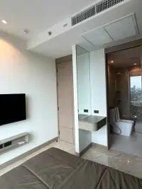 1 Bedroom Condo for Rent at Riviera Ocean Drive bedroom with TV, vanity mirror, and en-suite bathroom