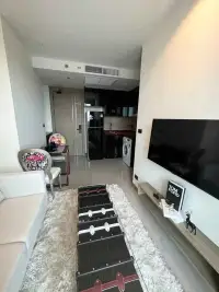 1 Bedroom Condo for Rent at Riviera Ocean Drive open-plan living area with kitchen and dining nook