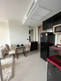 1 Bedroom Condo for Rent at Riviera Ocean Drive compact kitchen with black cabinetry and dining table