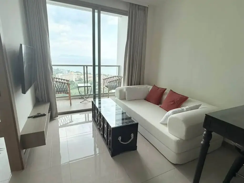 1 Bedroom Condo for Rent at Riviera Ocean Drive living room with white sofa, balcony, and sea view