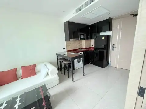 1 Bedroom Condo for Rent at Riviera Ocean Drive kitchenette with black cabinets, fridge, and washing machine