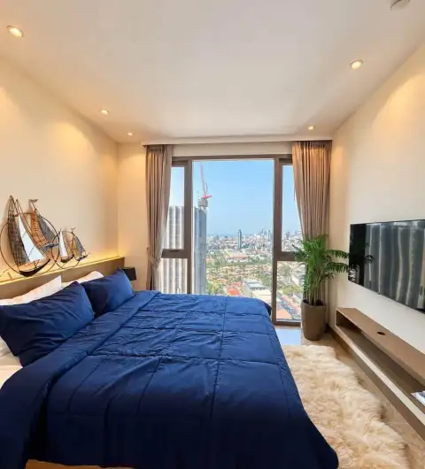 1 Bedroom Condo for Rent at Riviera Ocean Drive bedroom with blue bedding and city view window
