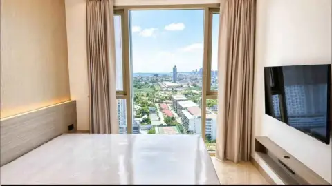 1 Bedroom Condo for Rent at Riviera Ocean Drive bedroom with bed facing floor-to-ceiling window and city view
