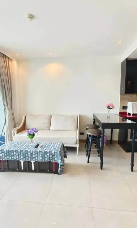 1 Bedroom Condo for Rent at Riviera Ocean Drive lounge area with sofa, dining table and bar stools