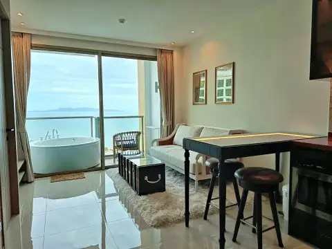 1 Bedroom Condo for Rent at Riviera Ocean Drive open-plan lounge with dining table and ocean balcony