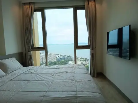 1 Bedroom Condo for Rent at Riviera Ocean Drive bedroom with wall-mounted TV and coastline view