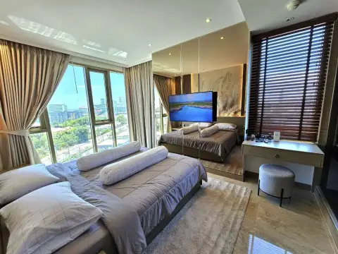 1 Bedroom Condo for Rent at Riviera Ocean Drive bedroom with floor-to-ceiling windows overlooking city and sea view