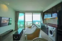 2 Bedroom Condo for Sale at Riviera Ocean Drive open-plan living room and kitchen with sea view balcony