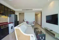 2 Bedroom Condo for Sale at Riviera Ocean Drive living area with kitchen, dining table, and hallway view