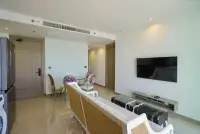 2 Bedroom Condo for Sale at Riviera Ocean Drive living room with rattan sofa and wall-mounted TV