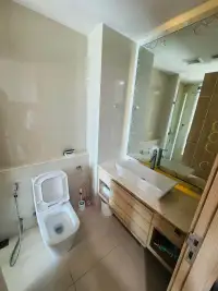 1 Bedroom Condo for Sale at Riviera Wong Amat Beach bathroom with toilet and mirrored vanity sink