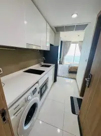 1 Bedroom Condo for Sale at Riviera Wong Amat Beach kitchen hallway leading to bedroom with ocean view