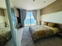 1 Bedroom Condo for Sale at Riviera Wong Amat Beach bedroom with balcony access and sea view