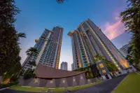 2 Bedroom Condo for Sale at Riviera Wong Amat Beach twin tower facade at dusk with illuminated entrance drive
