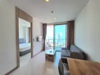 1 Bedroom Condo for Sale at Riviera Wong Amat Beach living area with bedroom view and ocean-facing balcony