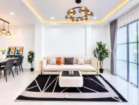 2 Bedroom Townhouse for Rent in East Pattaya living room with cream sofa and gold chandelier