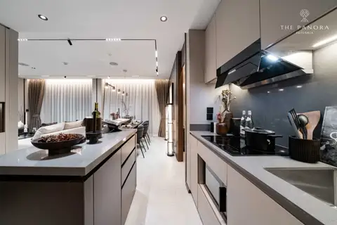 2 Bedroom Condo for Sale at Panora Estuaria modern kitchen with island, light cabinets, and integrated appliances.
