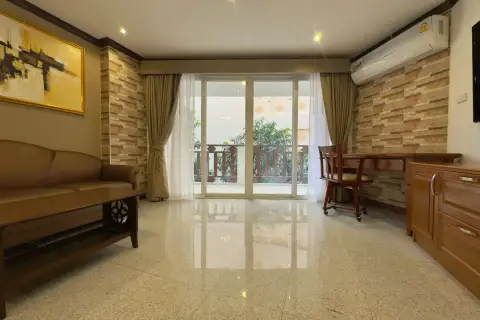2 Bedroom Condo for Rent at Royal Hill Resort seating area with desk, sliding glass doors and balcony view