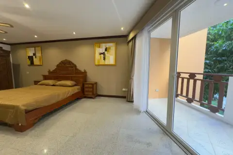 2 Bedroom Condo for Rent at Royal Hill Resort bedroom with carved wood bed frame and balcony doors