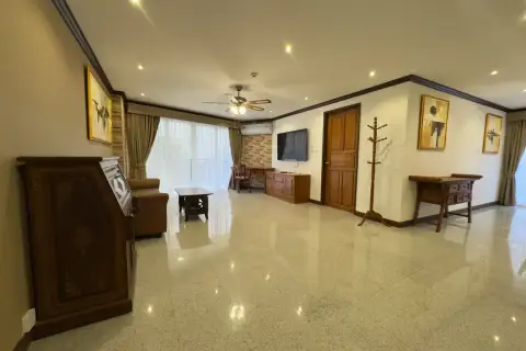 2 Bedroom Condo for Rent at Royal Hill Resort spacious living area with TV, wooden desk and coat rack