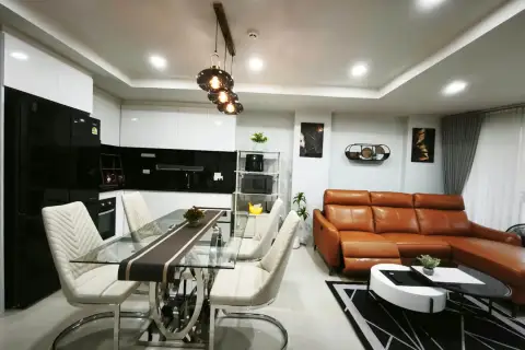 2 Bedroom Condo for Rent at Royal Hill Resort kitchen with black cabinets and glass dining table seating four