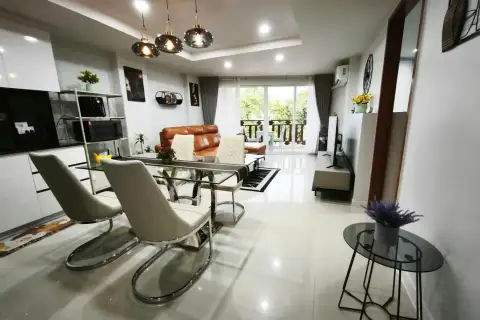 2 Bedroom Condo for Rent at Royal Hill Resort living area with balcony access and city view through sliding doors