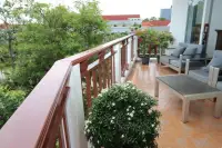 1 Bedroom Condo for Sale at Royal Hill Resort private balcony with lounge seating overlooking green treetops