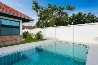 Royal View Village house exterior with a covered patio and green lawn.