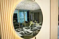 3 Bedroom Condo for Sale at SKYPARK Lucean Jomtien Pattaya elegant dining table set for six reflected in a round decorative mirror with crystal chandelier