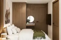 3 Bedroom Condo for Sale at Siam Oriental Beach, bedroom with bed, wooden wardrobe, and vanity mirror.