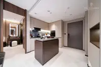 2 Bedroom Condo for Sale at Panora Estuaria kitchen with island and a view towards a dressing area and entrance door.