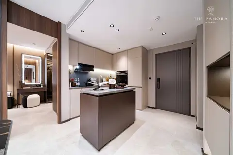 2 Bedroom Condo for Sale at Panora Estuaria kitchen with island and a view towards a dressing area and entrance door.