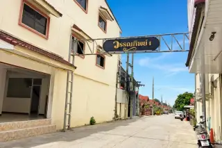 Wantip Village street view with overhead sign, buildings, and utility wires in Pattaya, Thailand.