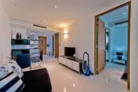 2 Bedroom Condo for Sale at The Sanctuary Wongamat open living area with TV console and hallway to bedroom