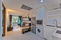 2 Bedroom Condo for Sale at The Sanctuary Wongamat kitchen with washing machine, fridge and microwave