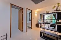 2 Bedroom Condo for Sale at The Sanctuary Wongamat hallway leading to bathroom and bedroom with shelving unit