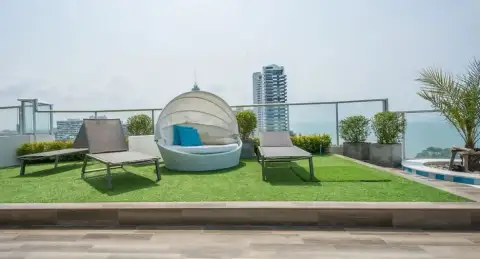 Sands Condominium aerial view of the tall white building overlooking the blue ocean and coastline in Pattaya.