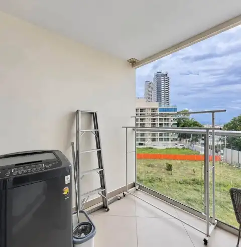 1 Bedroom Condo for Rent at Sands Condominium balcony with washing machine, ladder, and city skyline view
